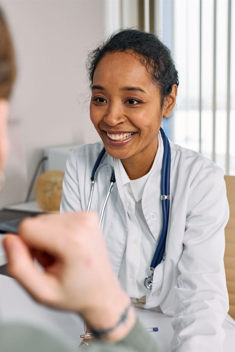 A GP listening closely to a patient during a consultation